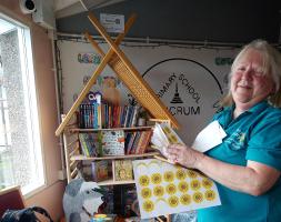 putting stickers onto the donated books ready for the children to choose which to take home